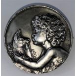 An early 20th century white metal circular brooch by Francois Thenot, cast with boy and lamb