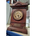 An Edwardian stained wood cased mantel clock