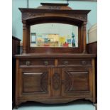 An Edwardian Art Nouveau carved walnut sideboard the mirror back with full turned side pillars,