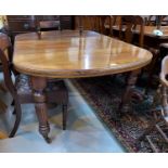 An early 19th century mahogany dining table with extending 'D' end top, on turned, fluted legs and