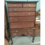 A reproduction mahogany chest on stand having 4 long and 4 short drawers to the chest, 1 long and