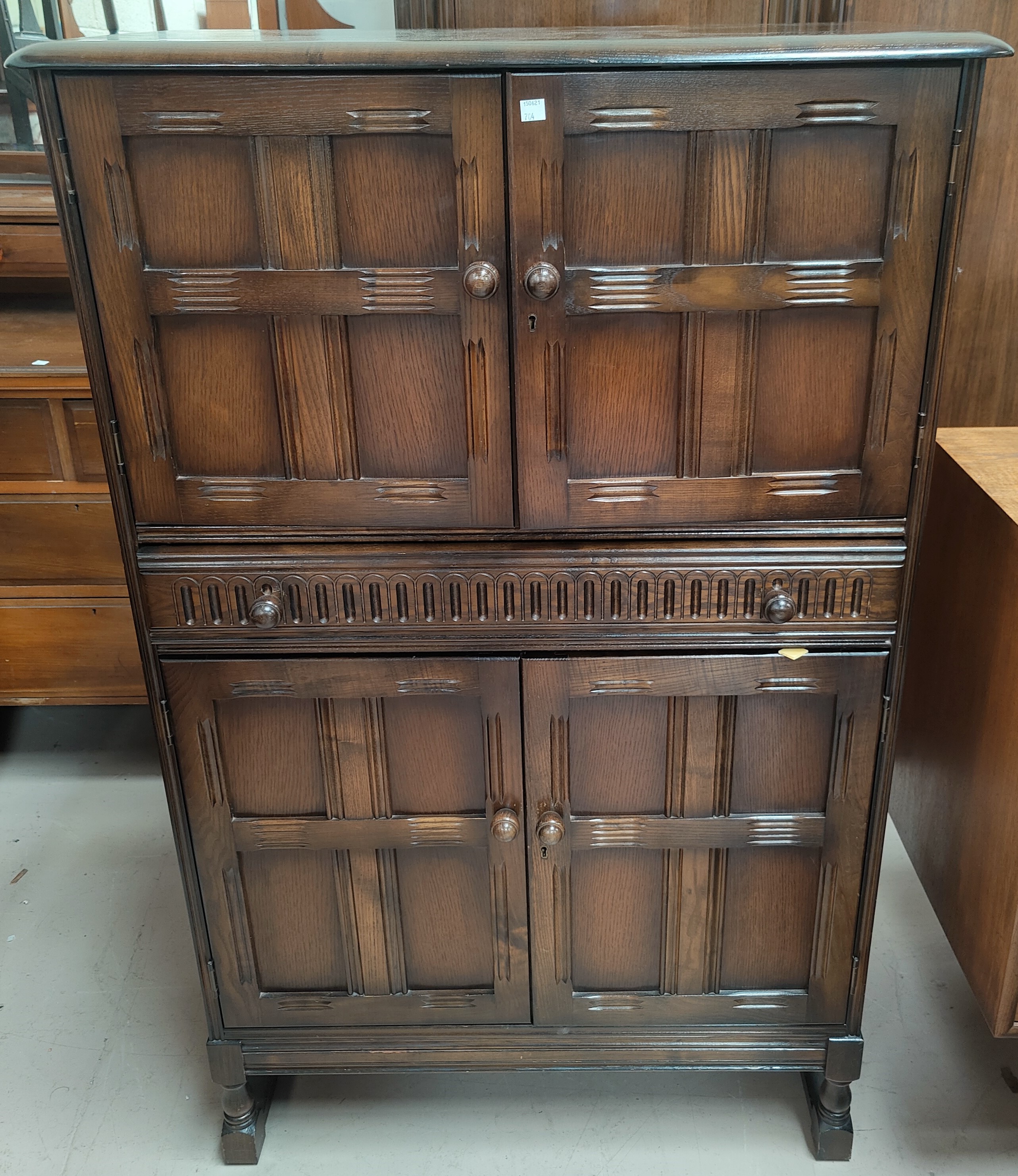 An Ercol traditional style cocktail cabinet, fitted cupboards and central drawer, 82 cm