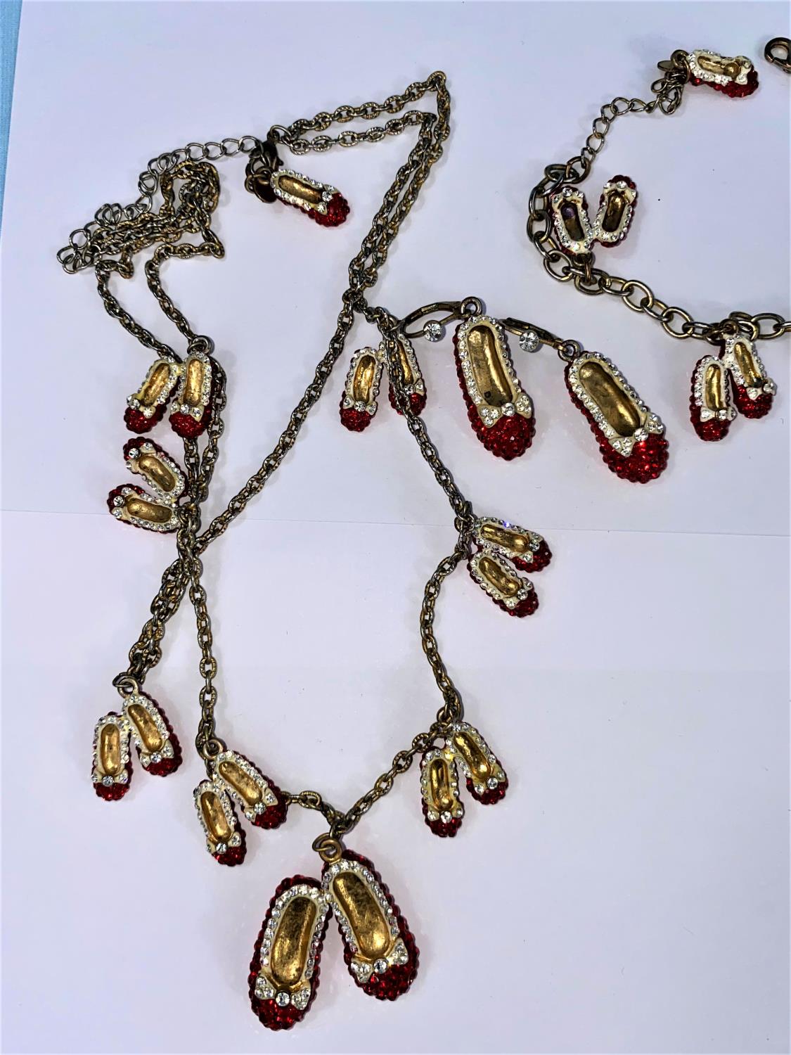 A Butler and Wilson 'Red Shoes' necklace, bracelet and earrings; a Butler & Wilson multi colour - Image 2 of 4