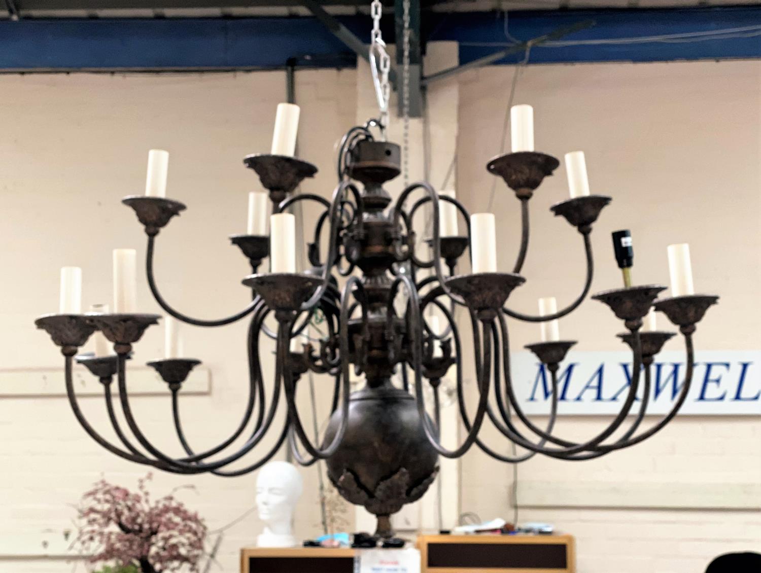 A large impressive modern bronze effect 18 branch chandelier, two tiers, on of 12 and one of 6,