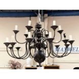 A large impressive modern bronze effect 18 branch chandelier, two tiers, on of 12 and one of 6,