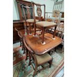 A reproduction Georgian mahogany dining suite comprising rounded rectangular extending twin pedestal