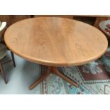 A mid 20th century Danish teak circular extending dining table with 2 spare leaves, stamped A M Made