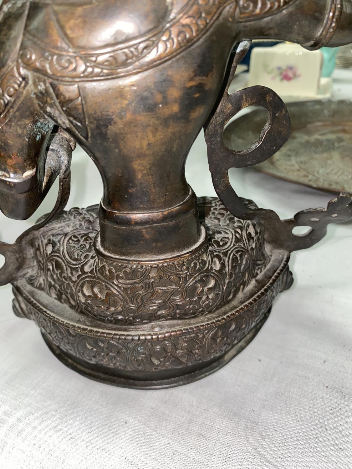 A Tibetan bronze figure of seated buddha with raised sword in one hand, seated in prayer position - Image 3 of 3