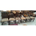 A set of 6 Wigan ladder back dining chairs with canted top rails and rush seats (a.f.)