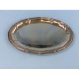 An oval white metal platter with ribbed decoration and moulded wavey border, stamped 835, 6.5oz,