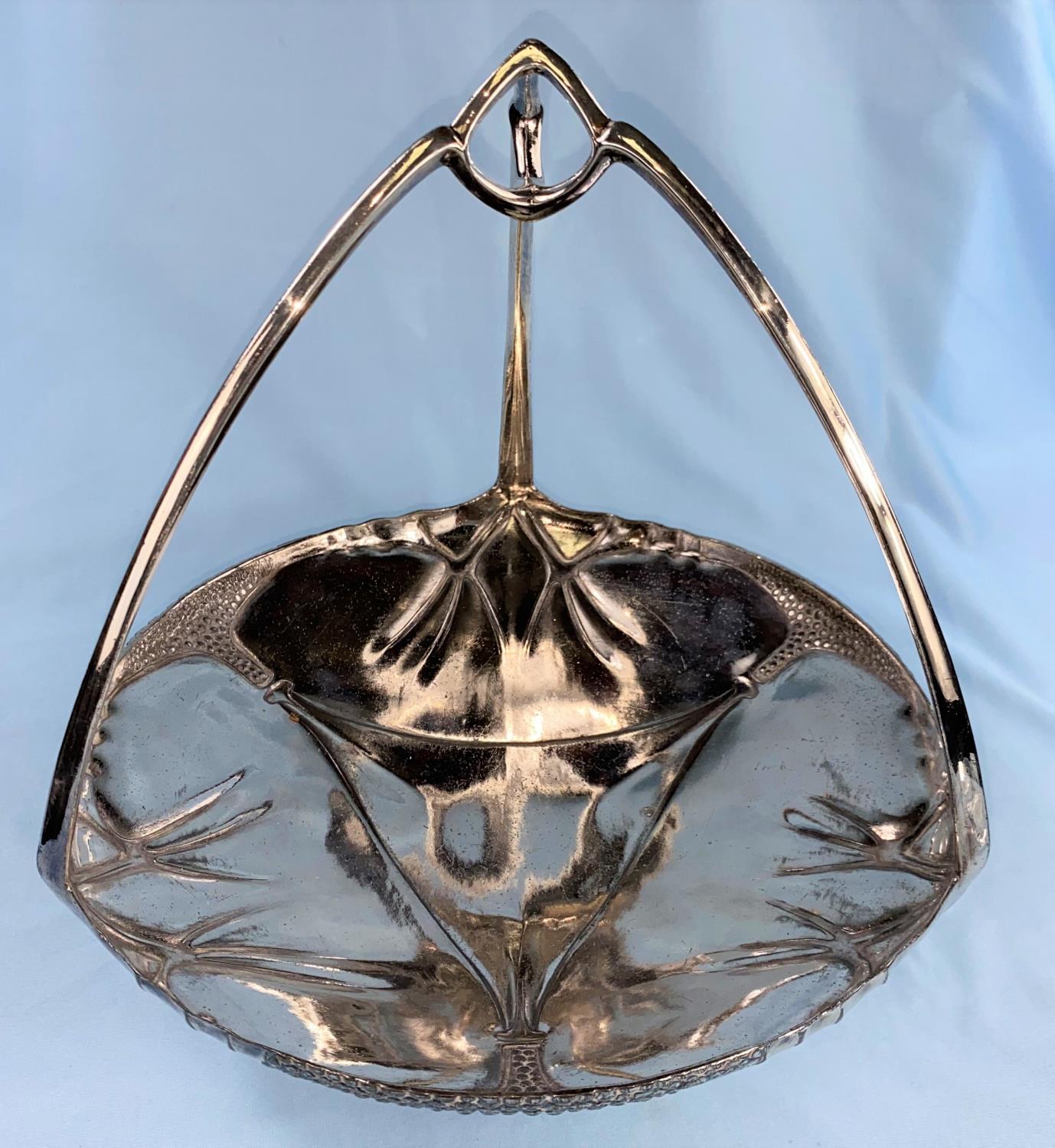 A silvered pewter Art Nouveau cake dish with triform handle, stamped Urania, height 22 cm