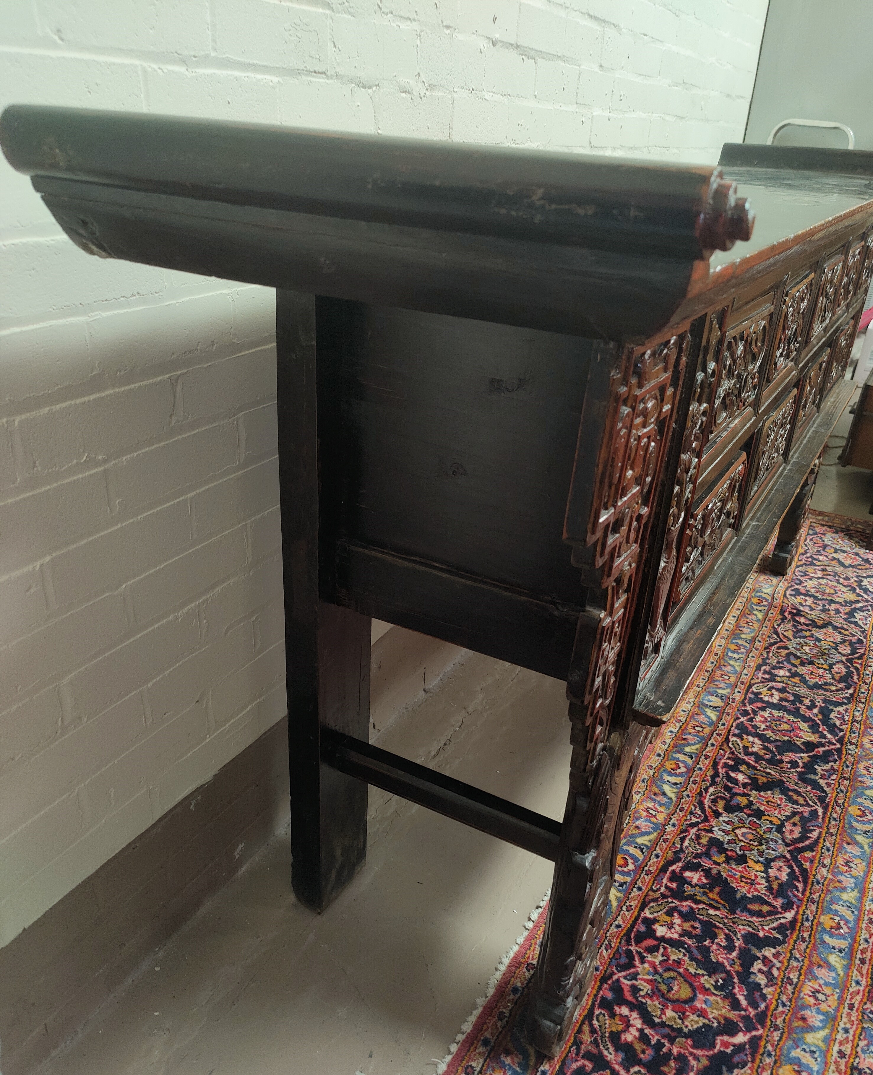 A late 19th/early 20th century Chinese unusual altar table, carved and lacquered with scroll end - Image 5 of 9