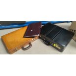 A brown and a black leather brief cases; a leather writing case