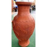 An oriental terracotta vase decorated with dragons, height 30cm and a large Chinese carved wood