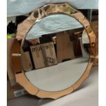 An Art Deco circular peach framed wall mirror