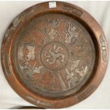 An Egyptian silver on copper plaque depicting deities, diameter 30cm and another Egyptian plaque