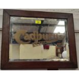 An advertising mirror Cadburys Cocoa with bevelled edge and wooden frame (some bubbling to