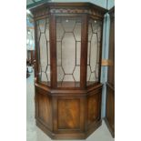 A reproduction canted mahogany full height display cabinet in the manner of "Reprodux" by Bevan &