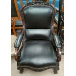 A Victorian mahogany carved armchair with carved floral design to crest, carved shell legs and