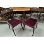 A set of 4 19th century Regency style mahogany dining chairs with deep red seats on reeded legs