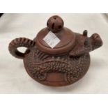 A Chinese Yixing teapot with relief dragon form with head as spout, mark to base and two Chinese