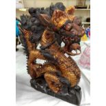 A South East Asian wooden carved figure of a three clawed dragon height 38cm