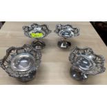 A set of 4 sweetmeat dishes on pedestal bases with pierced and embossed decoration, on weighted