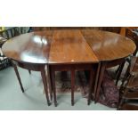 A late Georgian mahogany D-end dining table with central drop leaf section and two detachable D-