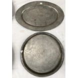 Two 20th century Chinese pewter trays - circular one with dragons, oval with mythical bird, 34cm x