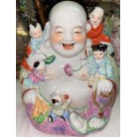 A Chinese figure of seated Hoti with children playing on him, height 28cm