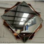 A large diamond shaped Art Deco mirror with 4 peach coloured sections, 83cm point to point