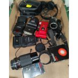 A Zenit film SLR camera no 86080595 with accessories including a Sicor 80-20 zoom lens, various