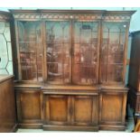 A Georgian style mahogany break front library bookcase in the manner of "Reprodux" by Bevan &