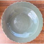 A Chinese celadon glaze dish with scalloped border, diameter 31cm and a carved Chinese hardwood