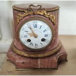 An French gilt mounted pink marble (rhodochrosite) clock with enamel dial