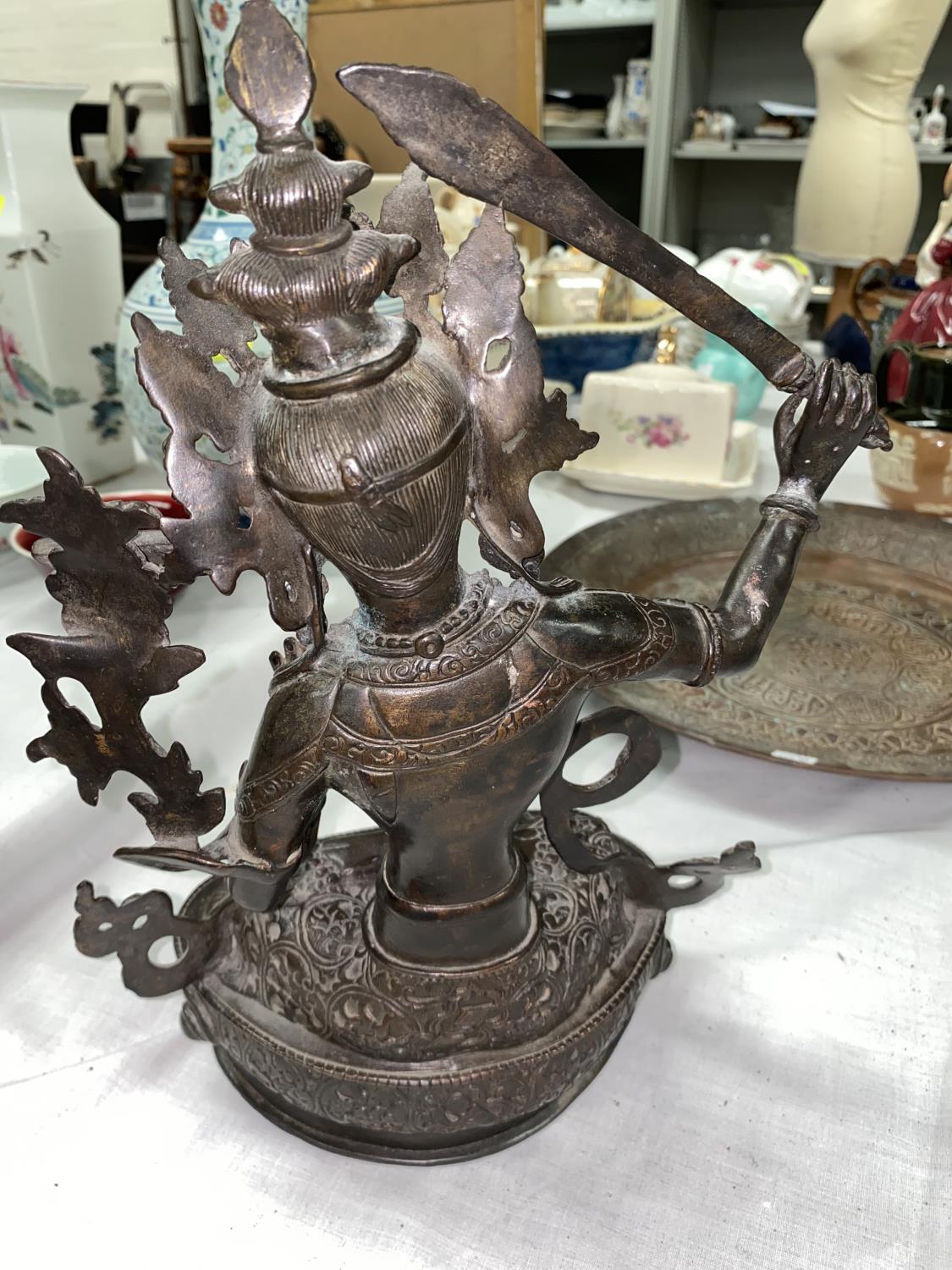 A Tibetan bronze figure of seated buddha with raised sword in one hand, seated in prayer position - Image 2 of 3