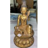 A Chinese gilt bronze figure of a seated buddha in prayer position with leaf mark to base