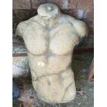 A reconstituted stone part male torso in the classical manner (restoration)