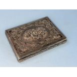 A rectangular continental white metal box with extensively embossed hinged lid depicting cherubs