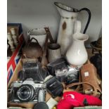 A hand operated sewing machine by Singer; a set of kitchen scales; 3 vintage cameras; cowbells; etc.