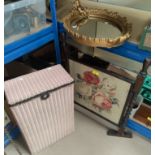 A Lloyd Loom small linen basket; an oak firescreen with tapestry panel; an oval gilt framed mirror