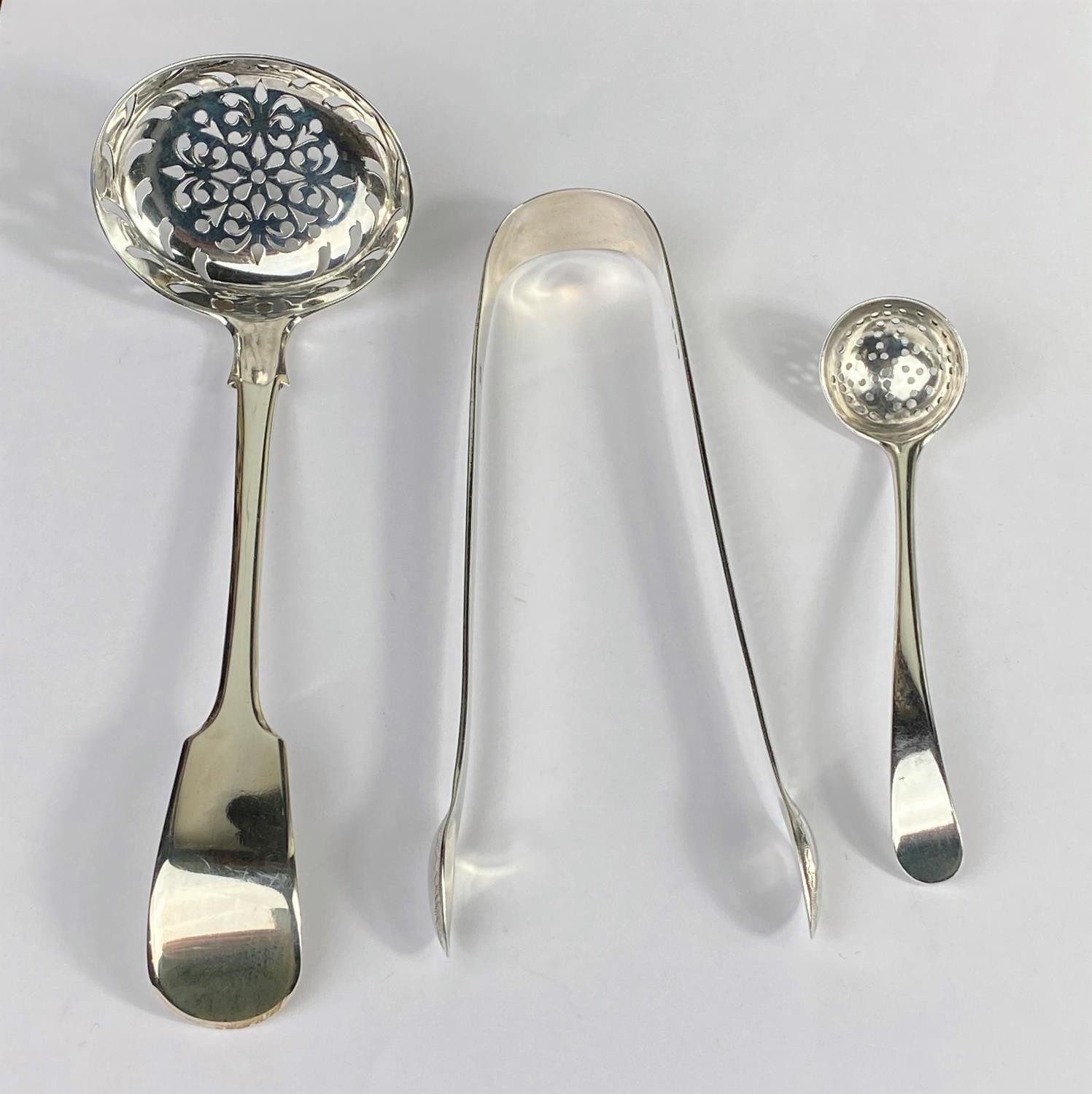 A William IV silver ladle, fiddle pattern with pierced bowl, IL.HL.CL London 1830; a similar spice