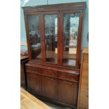 A reproduction mahogany wall unit with 3 glazed doors over 3 drawers & 3 cupboards