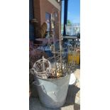 A zinc plated covered bin and various wrought iron plant holders