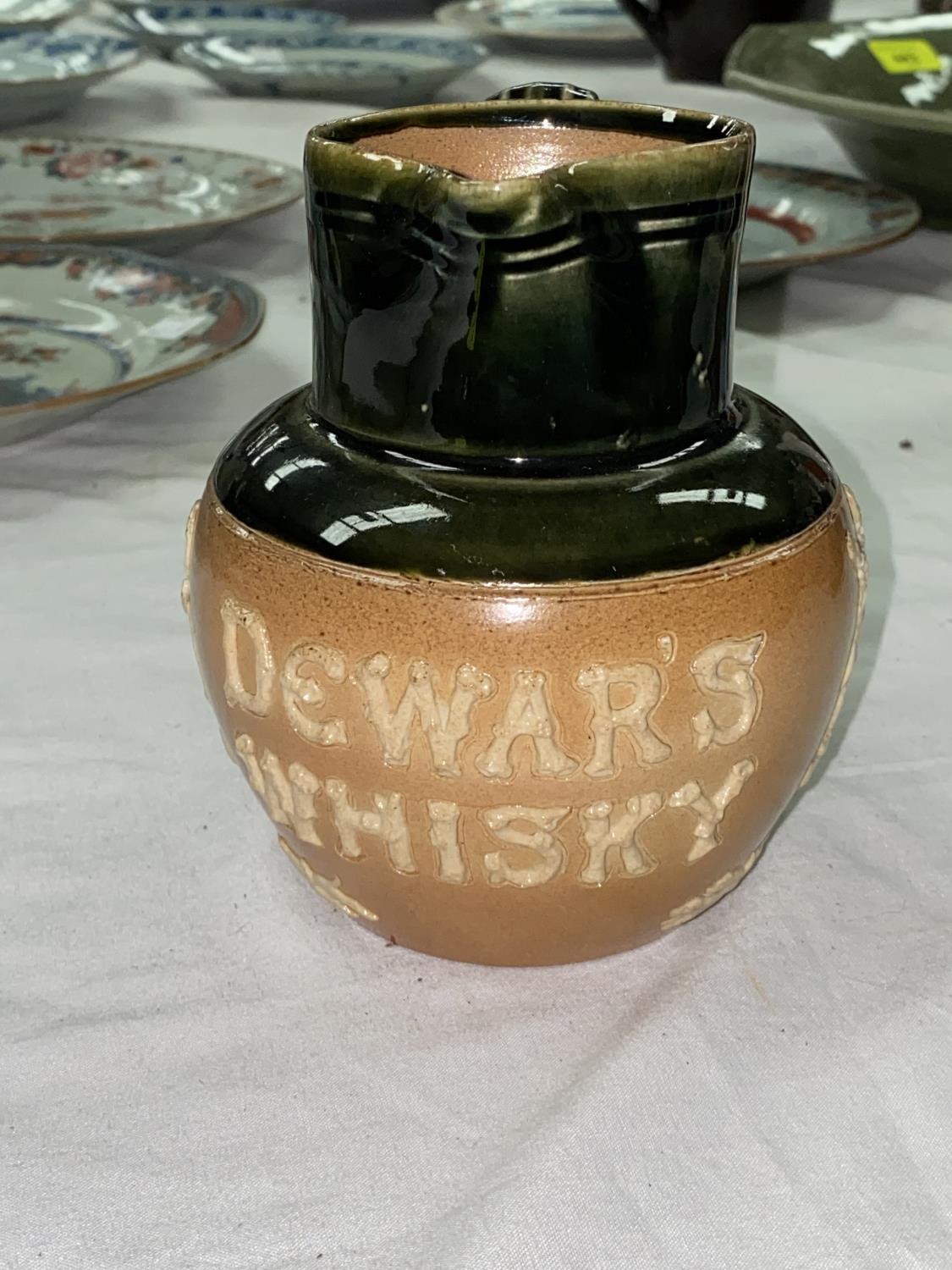 A DEWAR'S WHISKY Doulton stoneware advertising jug, 13cm (small chip to rim)