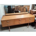 A mid 20th century lightwood dressing table with 6 drawers, single long mirror, on tapering legs