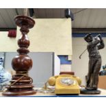 A large bronzed resin figure of a golfer in swing; a large turned wood lamp; a vintage telephone