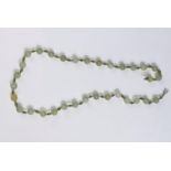 A hardstone 'apple jade' bead necklace