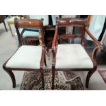 A Regency period set of 6 (5 + 1) mahogany dining chairs, with wide top rails, drop in seats in