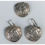 A silver earrings and brooch set, showing an image of an 18th century courting couple, hallmarked